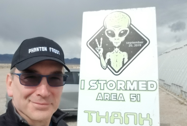 Alfred Wurr next to I Stormed Area 51 sign.