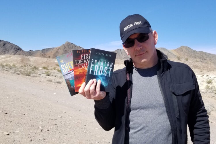 SFF Author, Alfred Wurr, holding PHANTOM FROST SERIES books at Dublin Gulch.